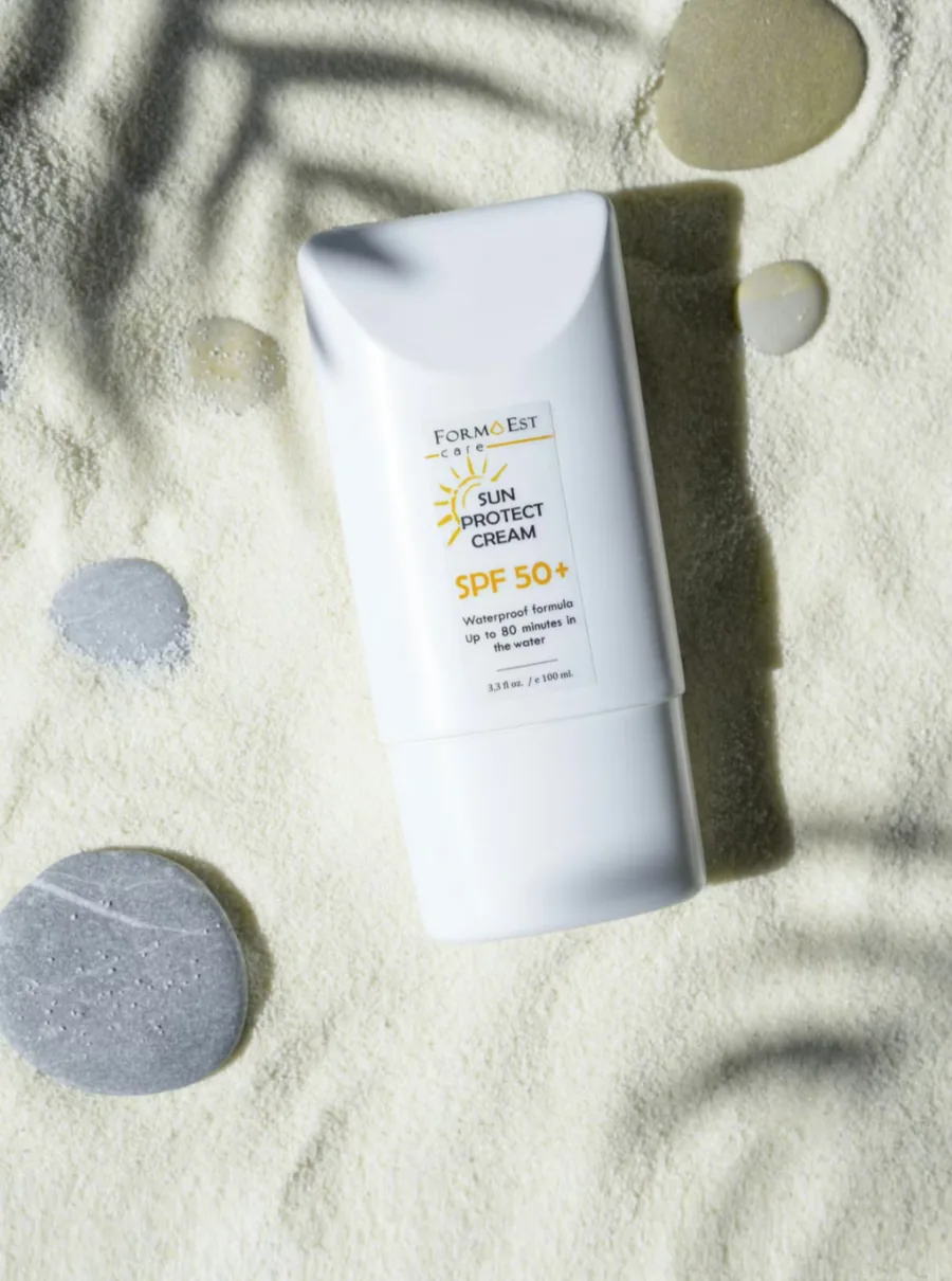 Static image: sunscreen bottle on sand